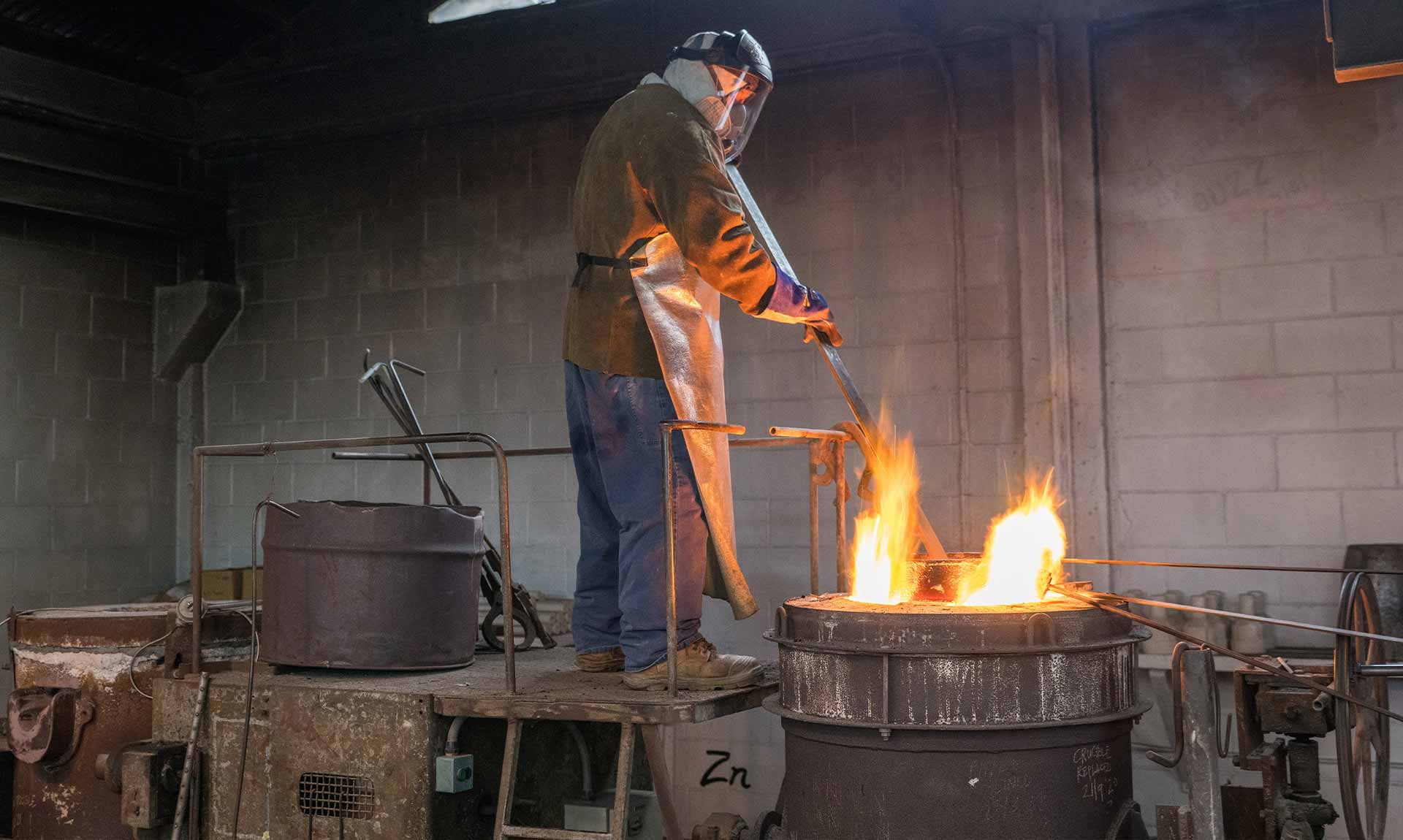 Removing any slag while the bronze comes up to temperature